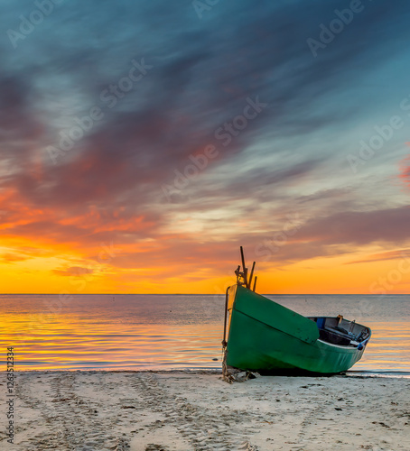 Coastal landscape of the Baltic Sea at dawn, primitive anchored fishing boats...