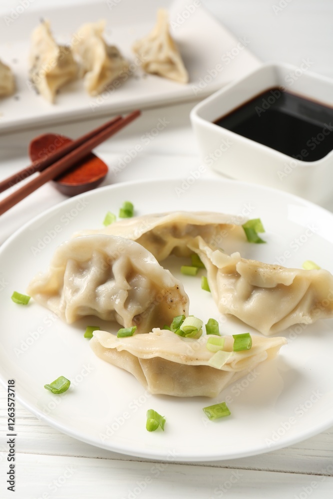 Delicious gyoza dumplings with chives served on white table, closeup Delicious gyoza dumplings with chives served on white table, closeup