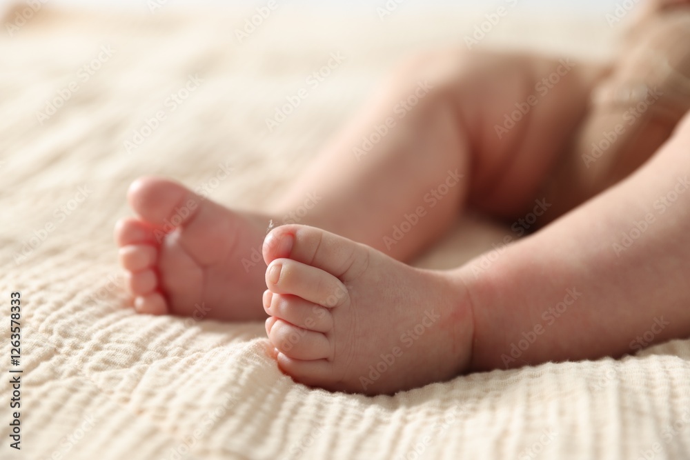 Little baby lying on bed indoors, closeup Little baby lying on bed indoors, closeup