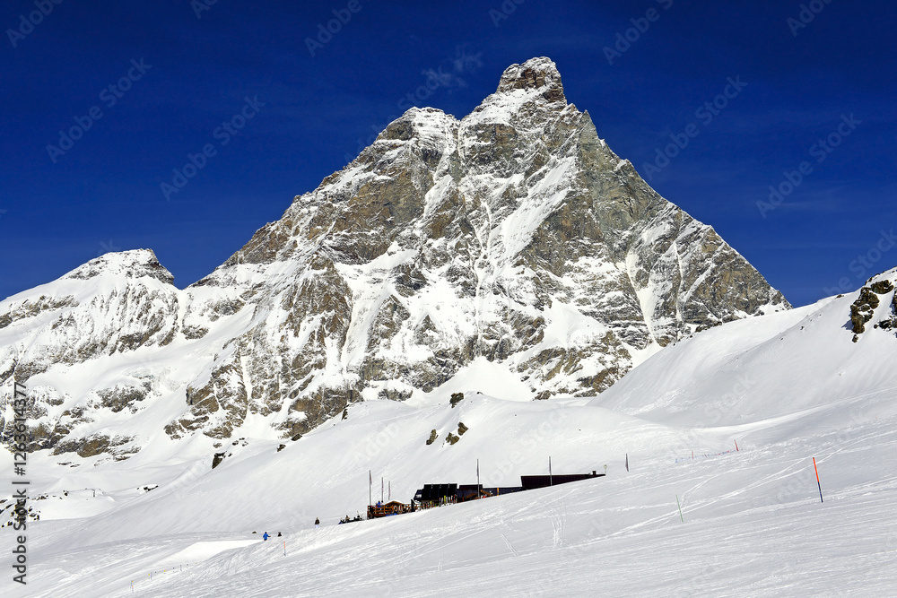 Snowy terrains below the Matterhorn peak - Monte Cervino, Italy. The mountain lies on the border between Switzerland and Italy, above the Swiss town of Zermatt and the Italian town of Breuil-Cervinia