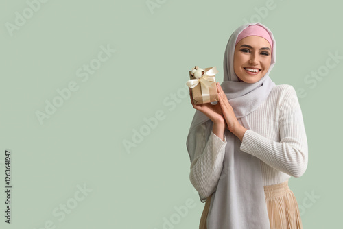 Young Muslim woman with gif...