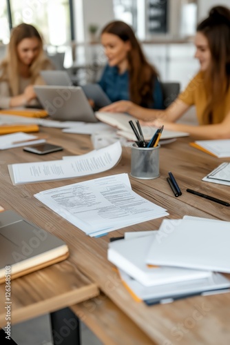 Female Study Group Gathered in Dorm Common Room with Laptops and Documents Exchanging Ideas Helping Each Other with Coursework
