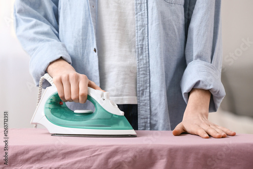 Woman ironing clean clothes...