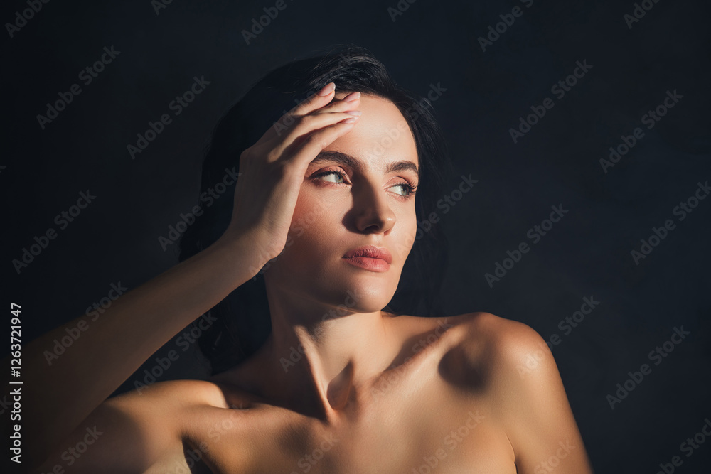 Fototapeta premium Photo of pretty lady look empty space dark color background touch silky face skin