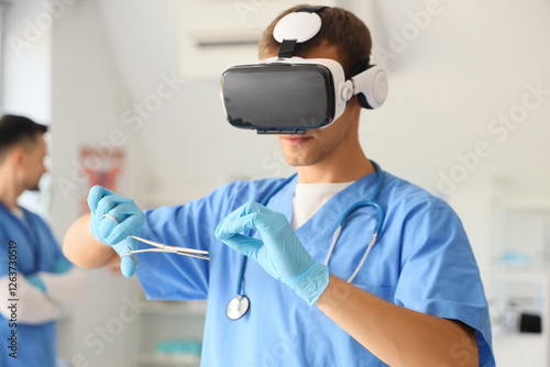 Male doctor with medical scissors using VR glasses in clinic