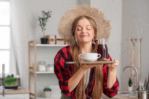 Young woman in straw hat wi...