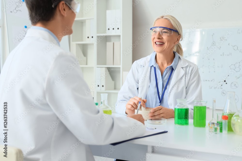 Female chemist with mortar and pestle at table in laboratory Female chemist with mortar and pestle at table in laboratory
