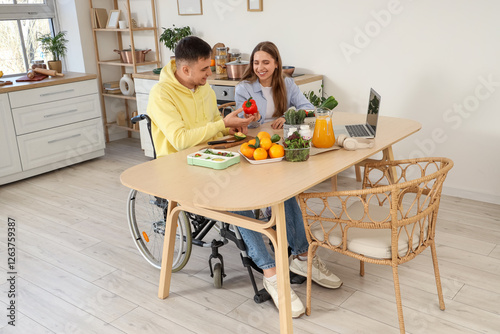 Young man in wheelchair and...