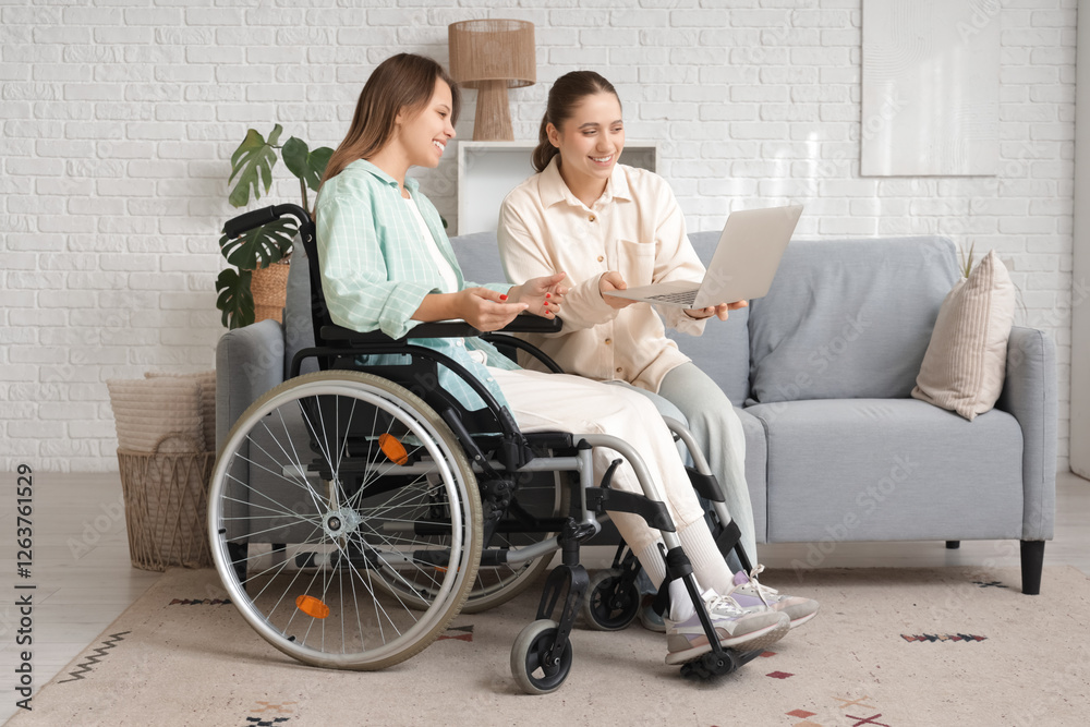 Young woman in wheelchair and her friend using laptop at home Young woman in wheelchair and her friend using laptop at home
