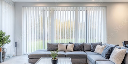 A sleek gray sectional sofa, elegantly angled to the left, features smooth upholstery and inviting curves that promise comfort and style in any living space photo