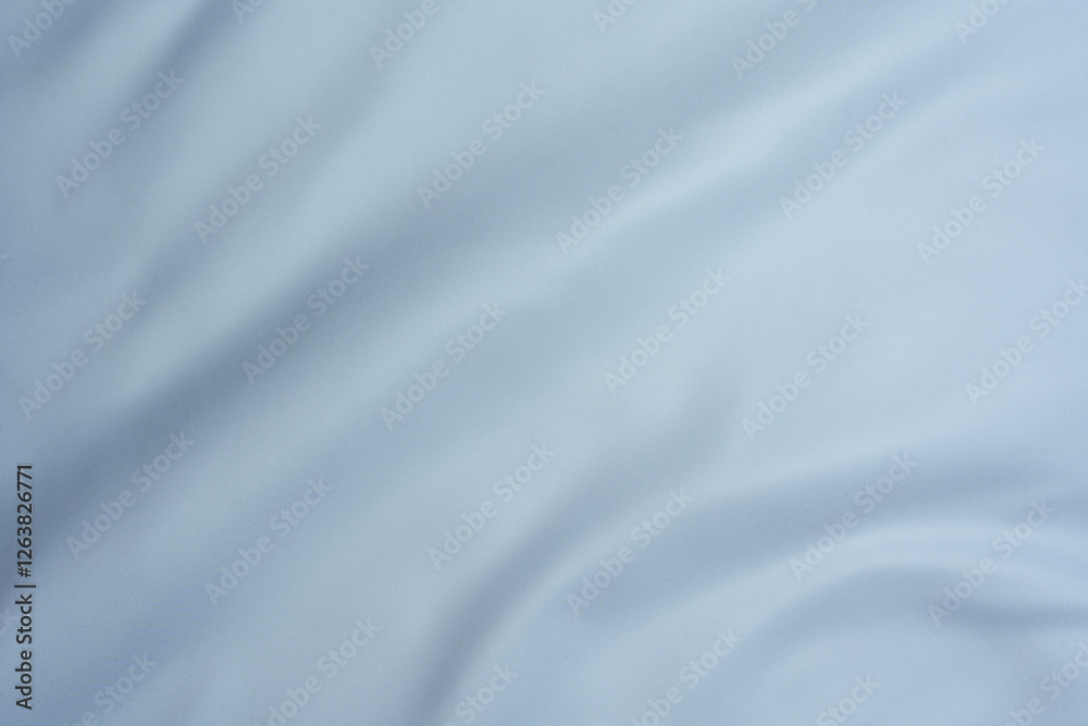 Light blue fabric texture with soft folds Light blue fabric texture with soft folds
