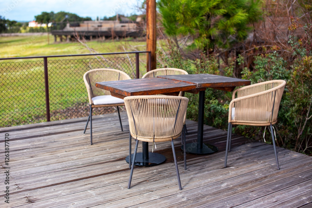 Wooden table and chairs on the terrace in the garden. Wooden table and chairs on the terrace in the garden.