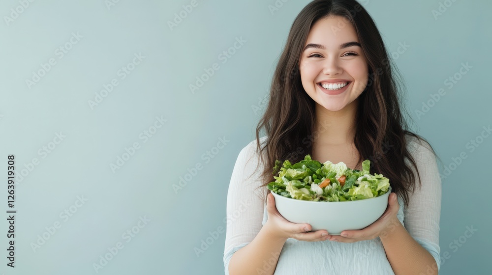 Smiling Young Woman Holding Fresh Salad Bowl on Blue Background Smiling Young Woman Holding Fresh Salad Bowl on Blue Background