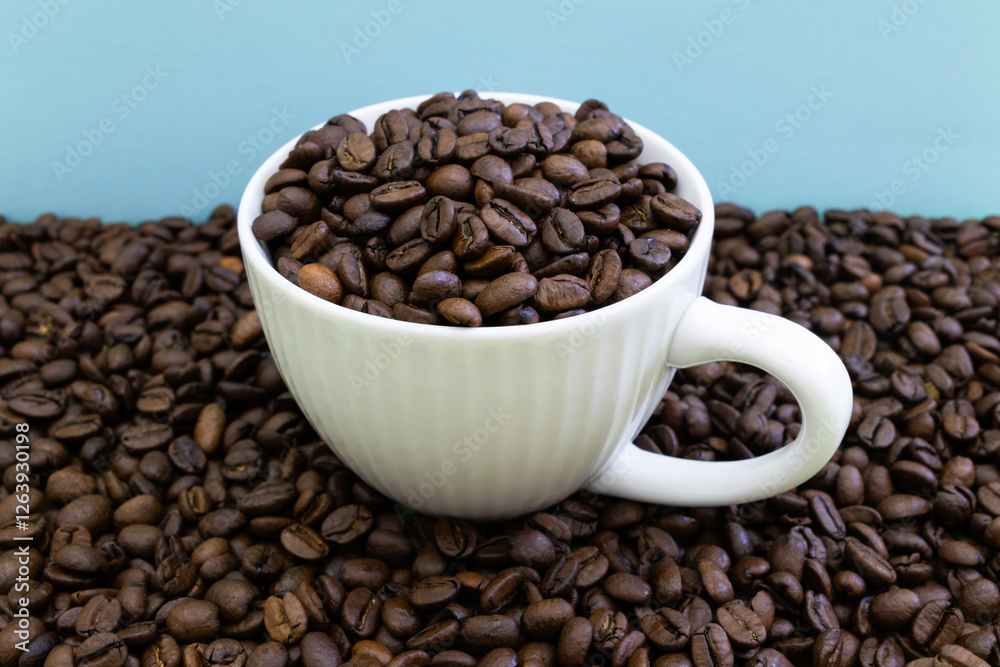 Fototapeta premium A white coffee cup is filled with coffee beans