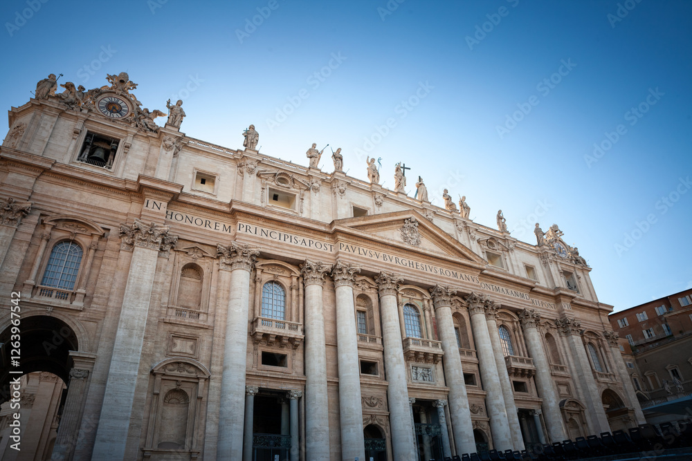 Saint Peter's Basilica in Vatican seenfrom St. Peter's Square. focusing on the iconic facade of the basilica. It's a papal basilica & a major landmark of Rome and Vatican. Saint Peter's Basilica in Vatican seenfrom St. Peter's Square. focusing on the iconic facade of the basilica. It's a papal basilica & a major landmark of Rome and Vatican.
