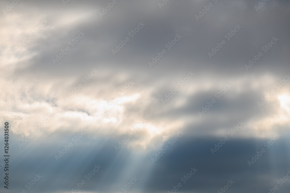 Dramatic sky with sun rays breaking through dark clouds Dramatic sky with sun rays breaking through dark clouds
