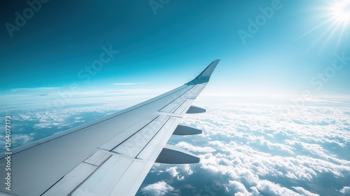 Close-Up View of Airplane Wings Gliding Through a Clear Sky Above Fluffy Clouds