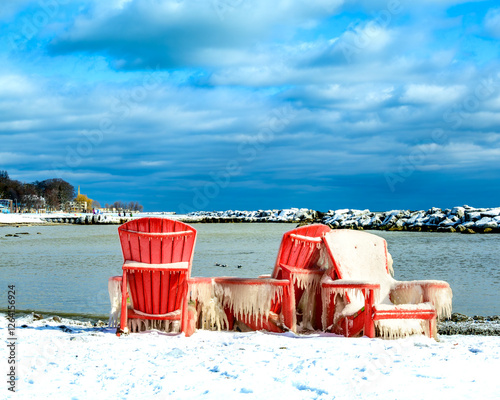 Canvas Print Beach chairs covered by ice after a snow storm on Kew Beach in Toronto shot in F