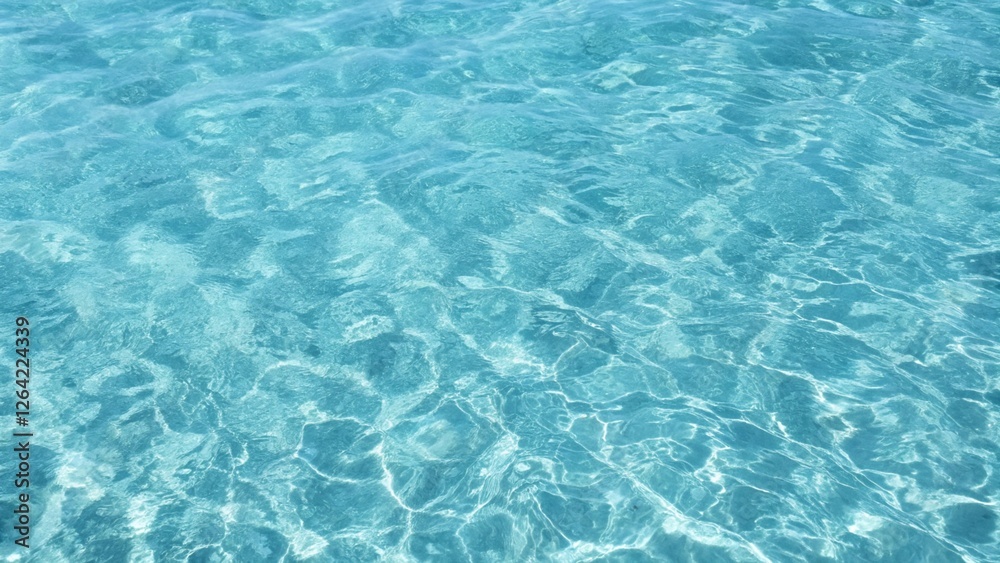 Blue ripped seawater in a swimming pool. Crystal clear ocean lagoon bay turquoise blue azure water surface, closeup natural environment. Tropical Mediterranean beach water background Blue ripped seawater in a swimming pool. Crystal clear ocean lagoon bay turquoise blue azure water surface, closeup natural environment. Tropical Mediterranean beach water background