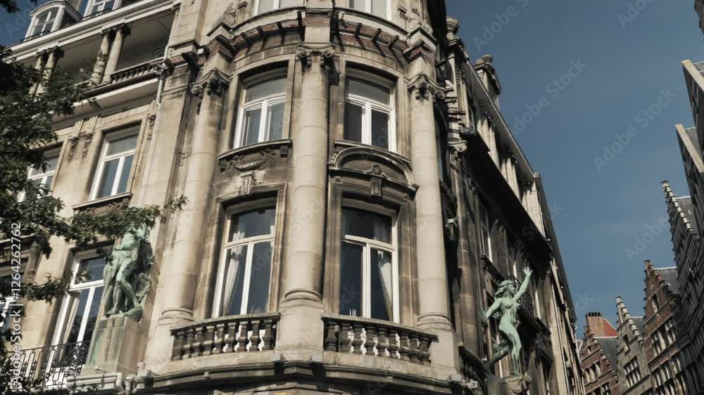 Historic Antwerp city architecture with intricate statues and detailed stone facades basking in sunlight against a crisp blue sky Historic Antwerp city architecture with intricate statues and detailed stone facades basking in sunlight against a crisp blue sky