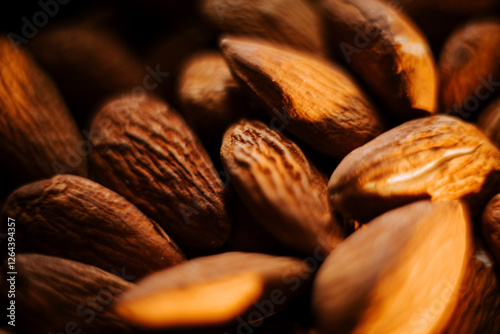 Tableau sur toile Almonds arranged on a plate create a striking contrast against a sleek black bac