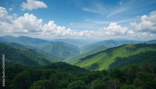 Stunning Panoramic View of Lush Green Mountains and Rolling Hills Under a Blue Sky with Puffy White Clouds