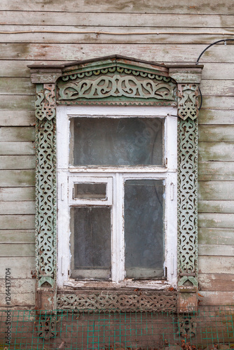 Window of an old wooden house with carved frames