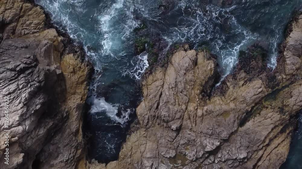 Topdown drone shot flying from the shore over the ocean. Topdown drone shot flying from the shore over the ocean.