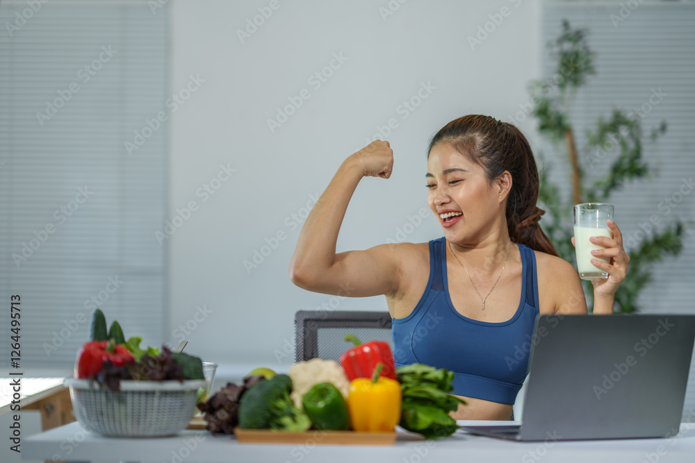 Young athletic woman flexing her biceps while drinking a glass of milk and eating healthy food, promoting a fit and healthy lifestyle with a balanced diet and regular exercise Young athletic woman flexing her biceps while drinking a glass of milk and eating healthy food, promoting a fit and healthy lifestyle with a balanced diet and regular exercise