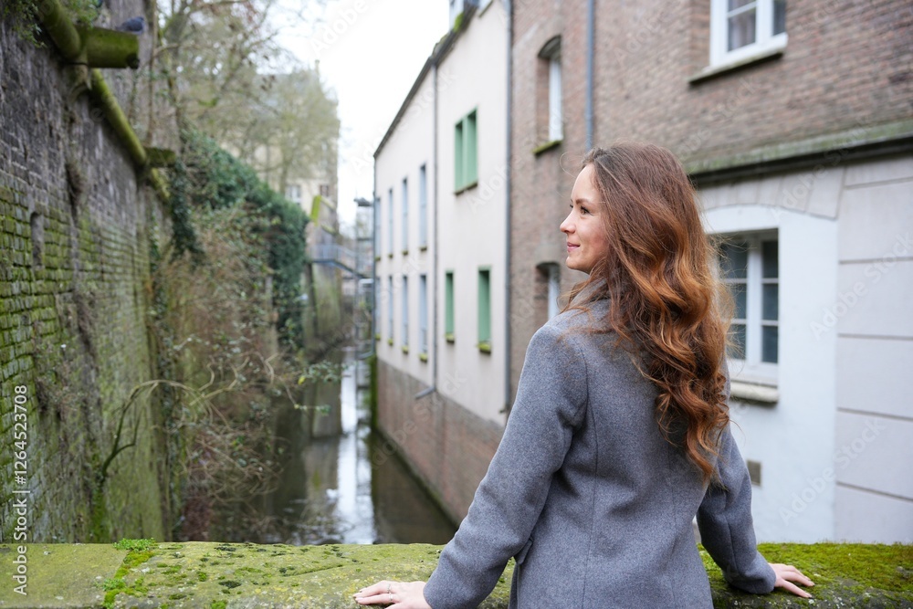 Woman admiring canal view in Amiens, France Woman admiring canal view in Amiens, France