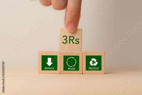 3Rs Concept. Reduce, Reuse, Recycle. Hand placing wooden block labeled 