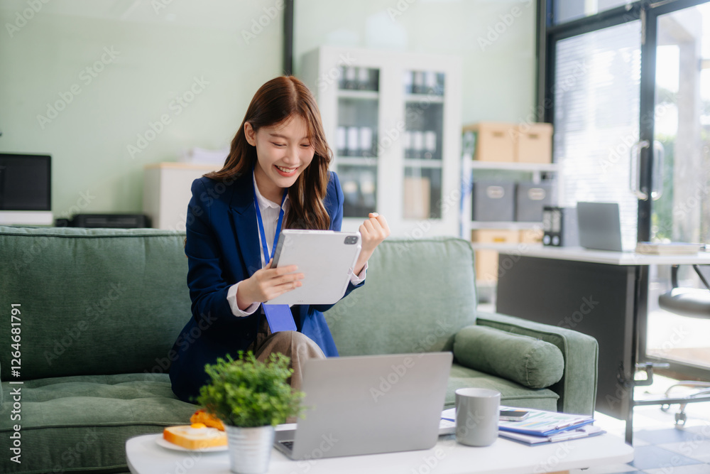 Asian businesswomen brainstorming in a cozy office, collaborating with a laptop and notebook. Perfect for teamwork Asian businesswomen brainstorming in a cozy office, collaborating with a laptop and notebook. Perfect for teamwork