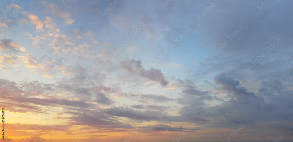 Dawn sky background. Colourful gold sky with clouds and sun light Dawn sky background. Colourful gold sky with clouds and sun light