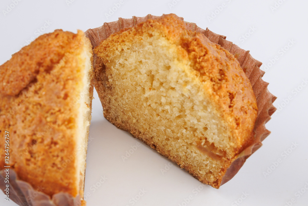 Cut in half cupcake in paper cup on white background. Cut in half cupcake in paper cup on white background.