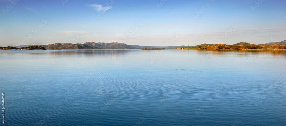 beautiful scenic landscape with mountain at the horizon under  between sky and water  in Norway