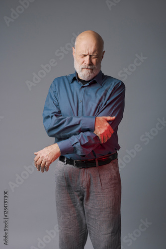 Senior man touching his painful elbow