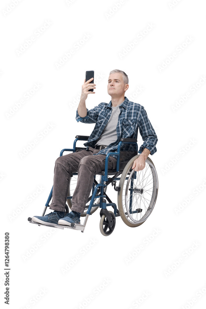 Fototapeta premium Man in a wheelchair using his smartphone