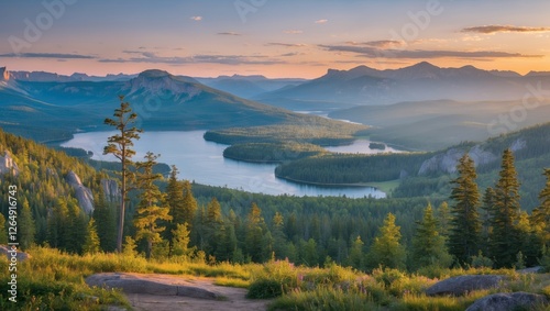 Breathtaking panoramic view of a serene lake surrounded by lush green forests and majestic mountains under a sunset sky Copy Space