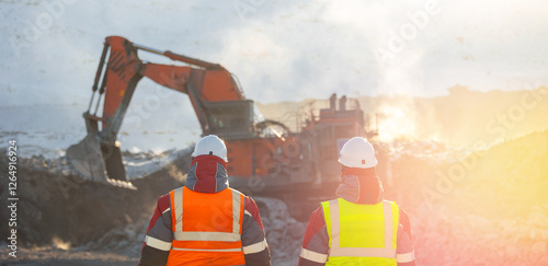 Coal mining operation with workers in heavy equipment scene on background excavators work Winter