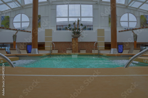 Obraz na płótnie Indoor solarium swimmingpool with hot tub whirlpool inside thermal suite in spa or wellness area onboard luxury modern cruiseship or cruise ship liner for beauty and balance w salonie
