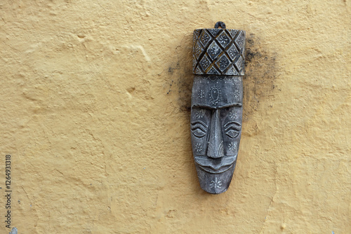 Wooden Indian black mask on the wall.