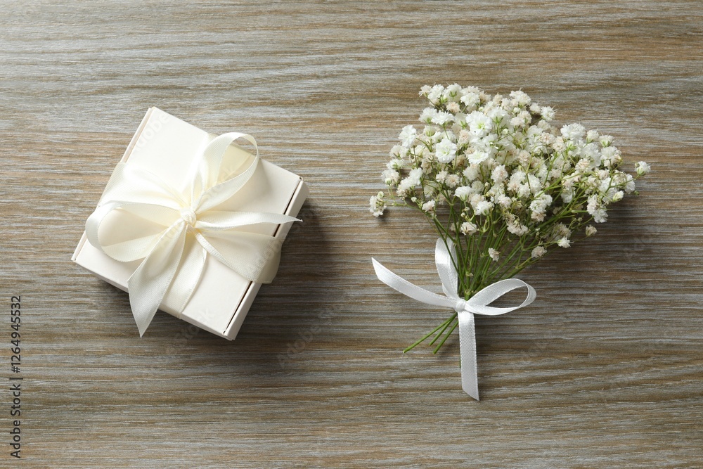 Top view photo with gypsophila flowers and gift box on wooden background Top view photo with gypsophila flowers and gift box on wooden background