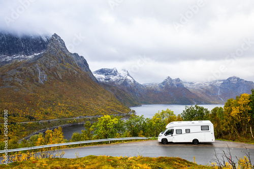 A motorhome parked by the road in the autumn landscape of Senja Island, Northern Norway, with fjords and mountains. photo