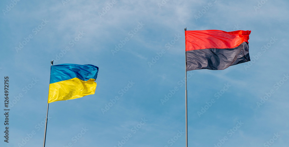 Ukrainian flag against the sky with a red and black flag symbolizing the war in Ukraine. Concept of the Ukrainian nation. Ukrainian flag against the sky with a red and black flag symbolizing the war in Ukraine. Concept of the Ukrainian nation.