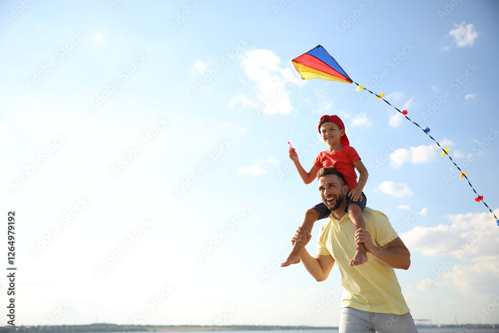 © New Africa - Happy father and his child playing with kite on sunny day. Spending time in nature © New Africa - Happy father and his child playing with kite on sunny day. Spending time in nature