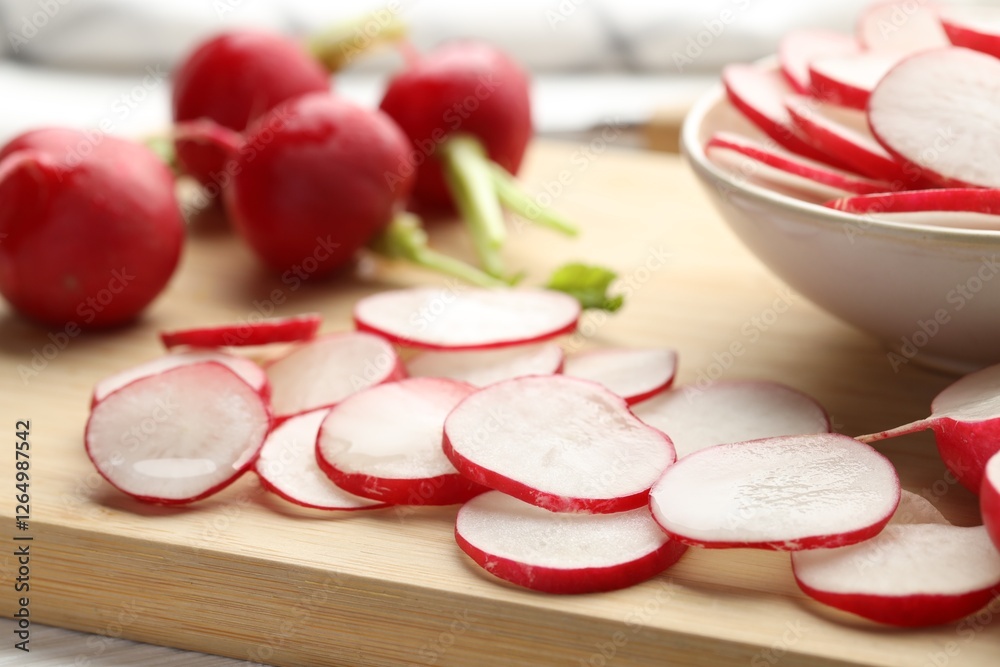 Fresh whole and cut radishes on table, closeup Fresh whole and cut radishes on table, closeup