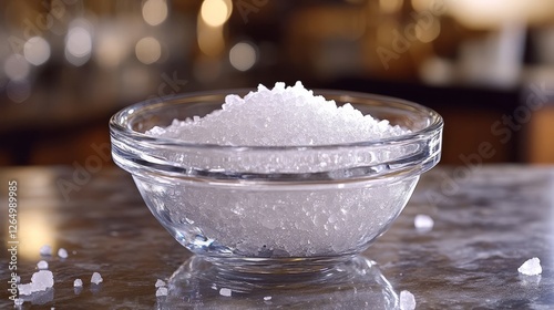 A saltwater solution in a glass bowl, gently stirred, with salt crystals visible  photo