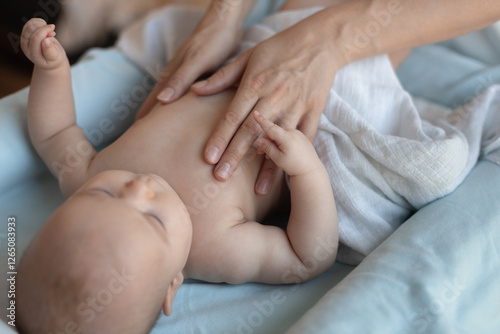 Baby massage. Massage therapist working with cute baby