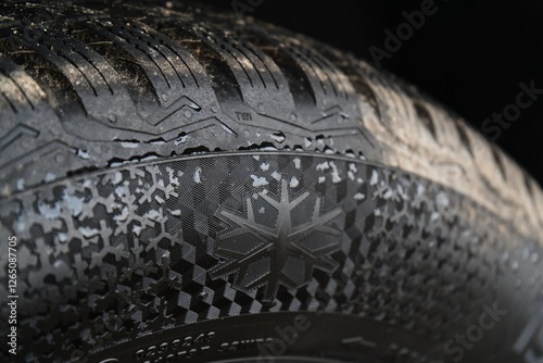 Close-Up of Winter Tire with Snowflake Symbol and Tread Pattern