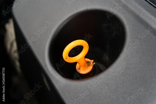 Close-Up of Engine Oil Dipstick Handle in Car Engine photo